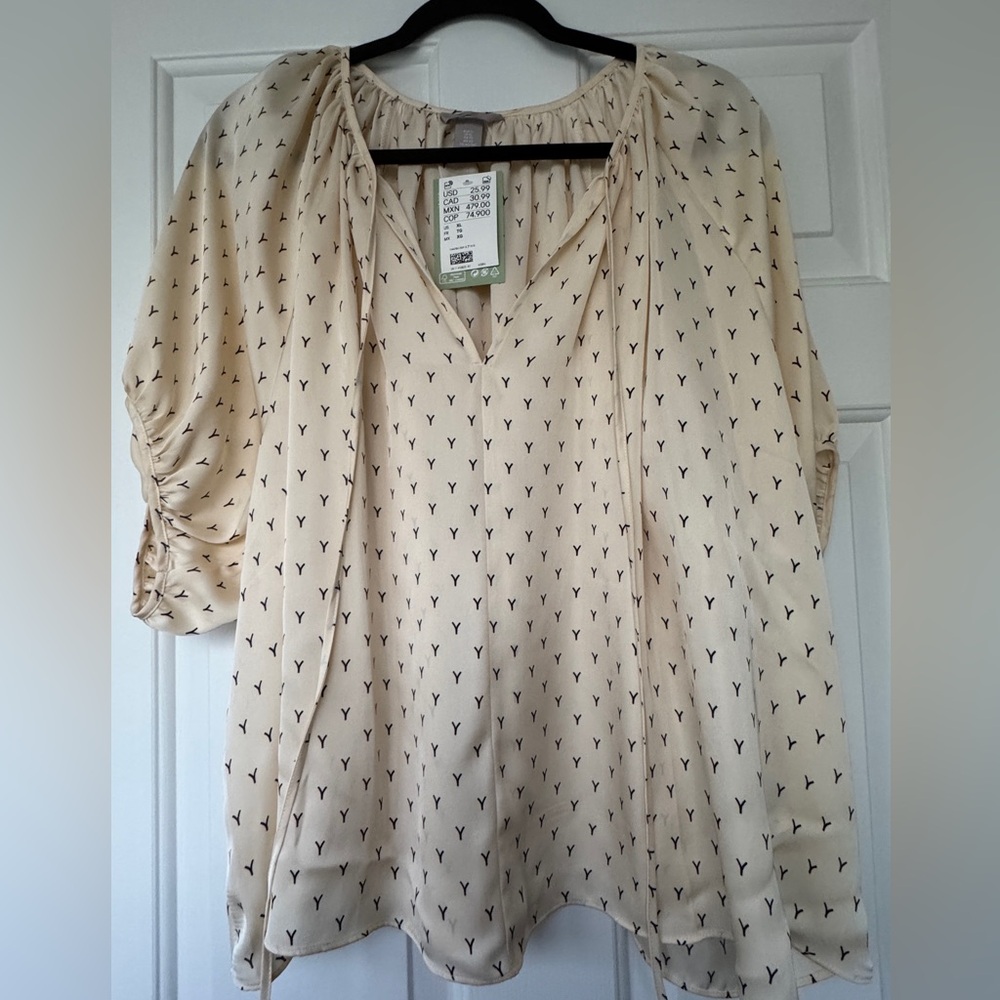 Women's H&M Blouse Size XL. Cream with Black details all over the shirt.